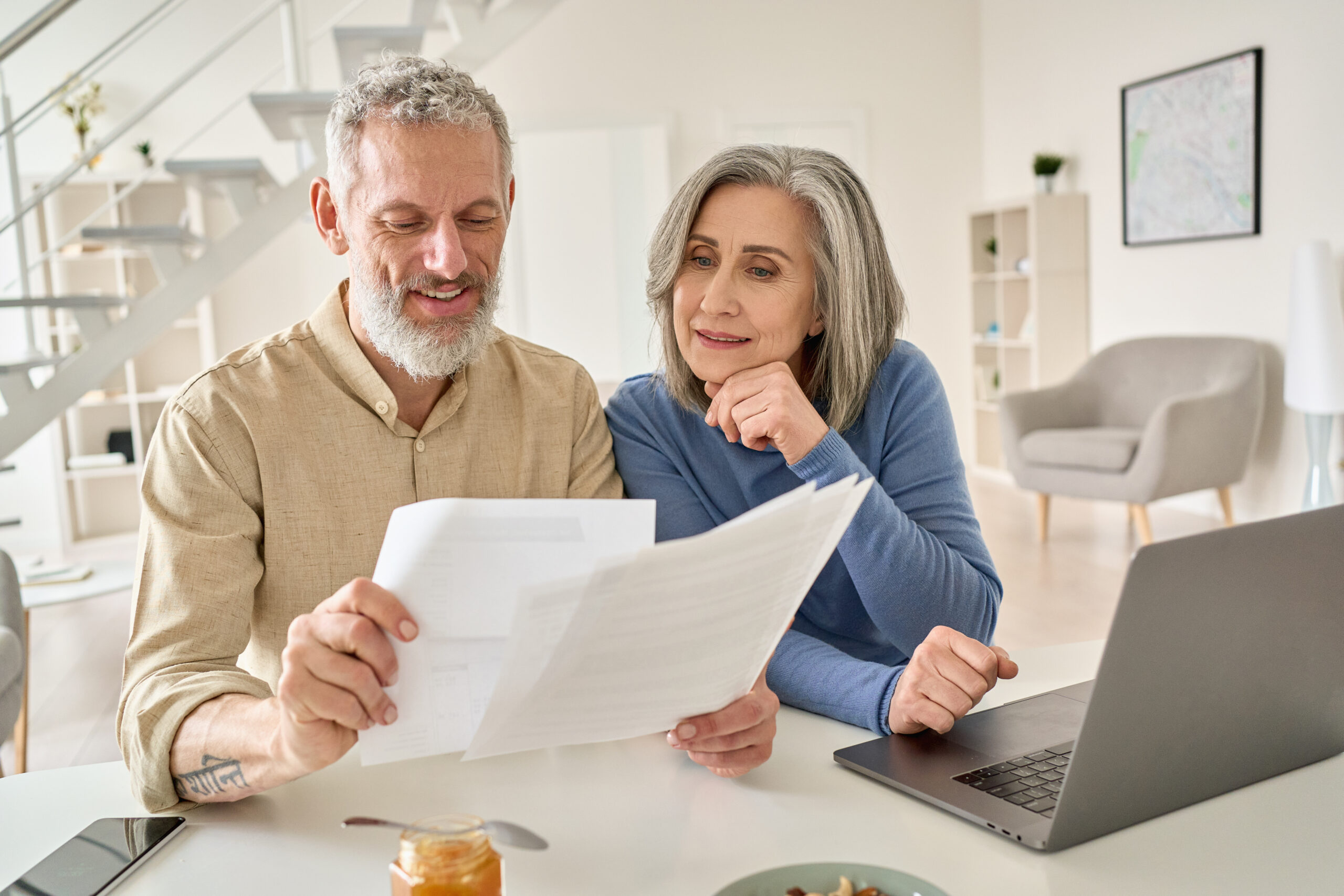Middle,Aged,Senior,Old,Couple,Holding,Documents,Reading,Paper,Bills